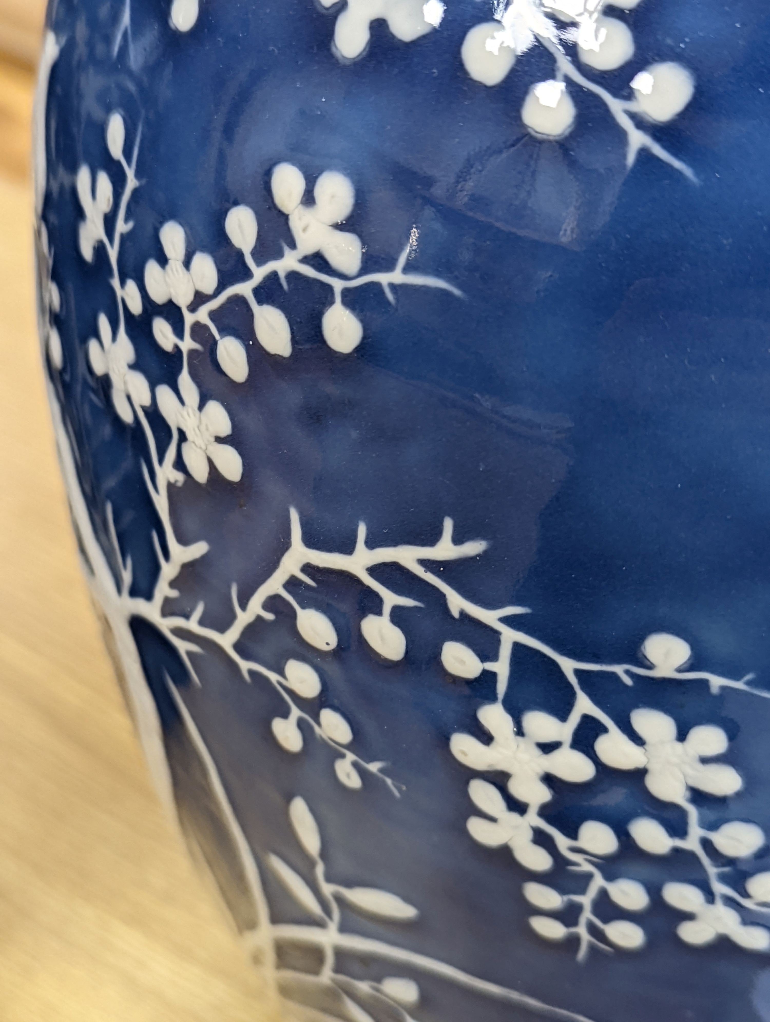 A pair of large 19th century Chinese slip decorated blue ground vases, restored, 59cm